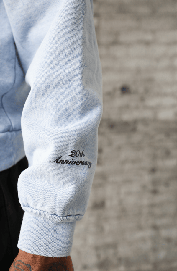Bellargo 20th Anniversary Limited Edition Valedictorian Washed Pullover Left Arm Detail View in Arctic Blue